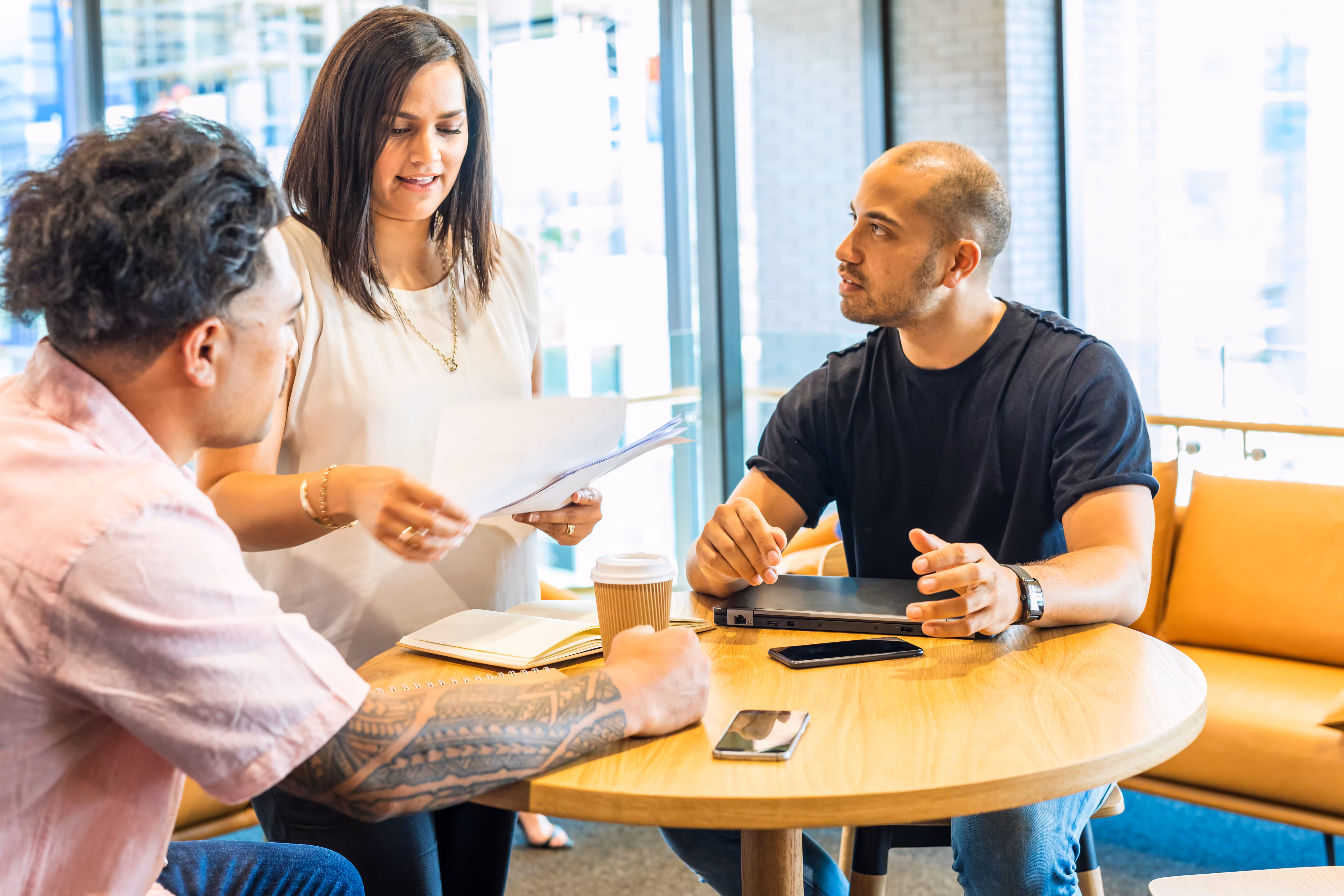 3 people talking around a table
